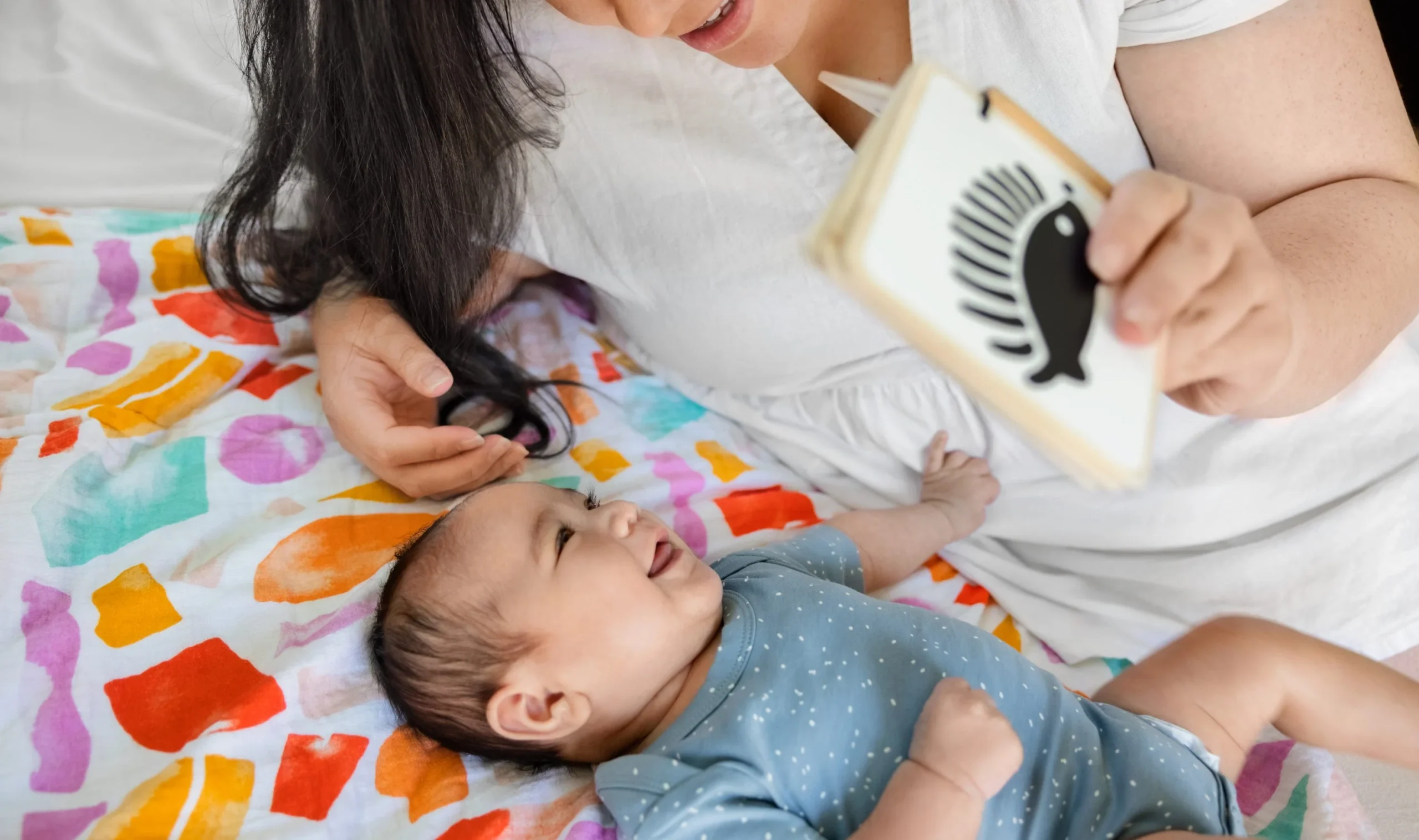 Mom showing visual cards to a baby