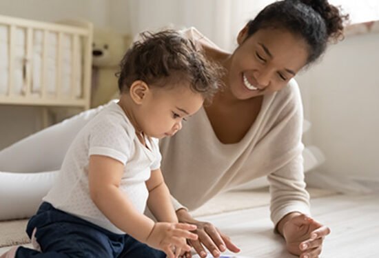 Baby playing with a mother