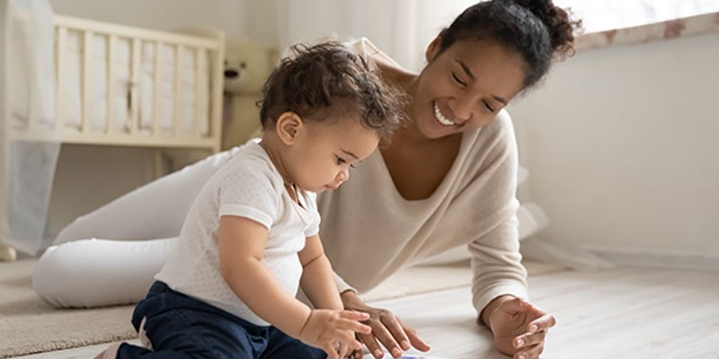 Baby playing with a mother
