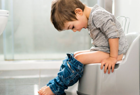 Toddler sitting on potty trainer