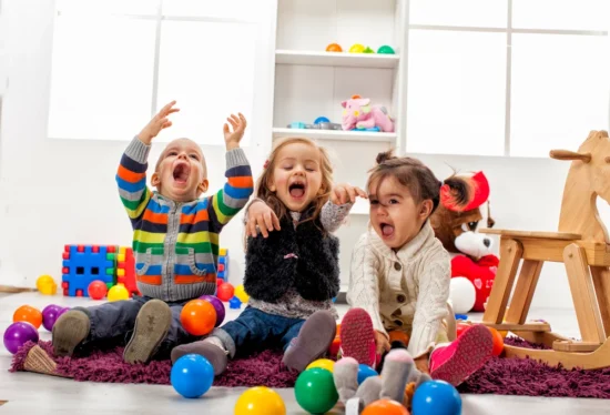 3 toddlers playing with balls