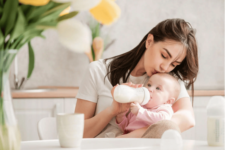 Mother bottle feeding a baby